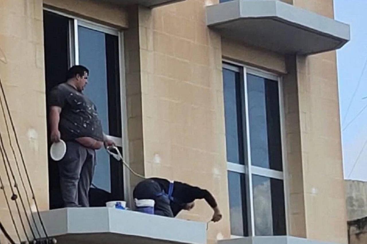 a man is seen on the balcony of a building in the city of beirut
